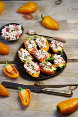 Yellow bell peppers stuffed with ricotta and olives. Healthy snack. Snack diet. Autumn cuisine. Stuffed paprika pepper. Keto diet recipe.