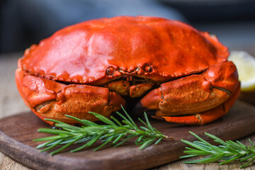 Seafood shellfish Steamed red crab or Boiled stone crab - Fresh crab with ingredients lemon rosemary on wooden board