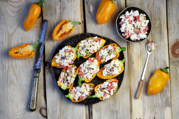 Yellow bell peppers stuffed with ricotta and olives. Healthy snack. Snack diet. Autumn cuisine. Stuffed paprika pepper. Keto diet recipe.