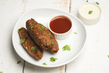 indian chicken tikka shish kofte kebabs. Delicious homemade Indian Starter Mixed Vegetable Kebab Platter dipped in mayonnaise coriander leaf. Seekh Kebab grilled meat skewers, Turkish and Arabic food.