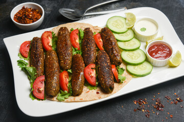 indian chicken tikka shish kofte kebabs. Delicious homemade Indian Starter Mixed Vegetable Kebab Platter dipped in mayonnaise coriander leaf. Seekh Kebab grilled meat skewers, Turkish and Arabic food.