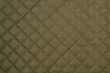 Quilted fabric. The texture of the blanket.	
