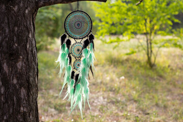 Fototapeta premium Handmade dream catcher with feathers threads and beads rope hanging