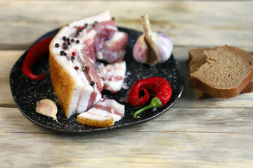 Selective focus. Fresh lard on a plate. Salting lard.