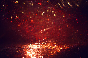 Naklejka premium background of abstract red, gold and black glitter lights. defocused