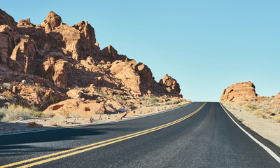 Panoramic view of Nevada desert road, color toned picture, USA.