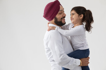 A SIKH FATHER AND DAUGHTER LAUGHING AND HAPPILY SPENDING TIME TOGETHER	