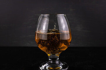 Glass of cognac with drops