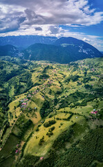 Beautiful rural area between the Piatra Craiului and Bucegi mountains, Magura, Pestera, Moieciu, Transylvania, Romania as seen from above with a drone. Aerial view
