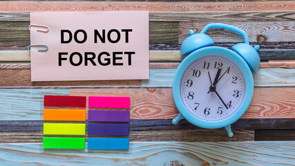 Don't forget to notice the graphic concept of reminder words, text on wooden colored background, alarm bells and stickers next to it.