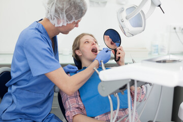 Young woman on dental checkup in modern dentist office. High quality photo