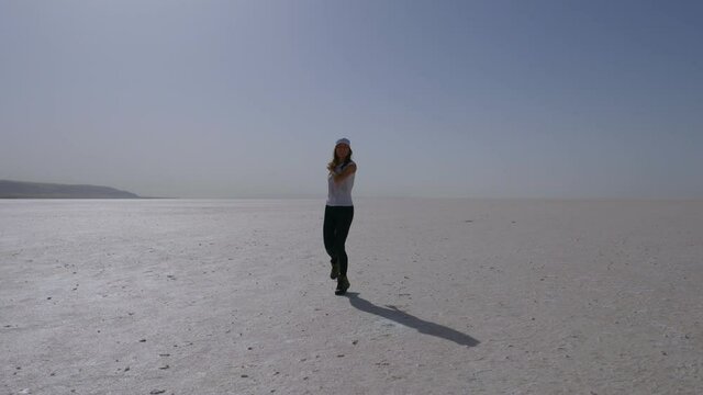 girl running towards camera on salt lake in Turkey, Tuz Gulu, tourism in Turkey