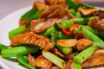Close up shot of fried pork intestines with string bean