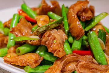 Close up shot of fried pork intestines with string bean