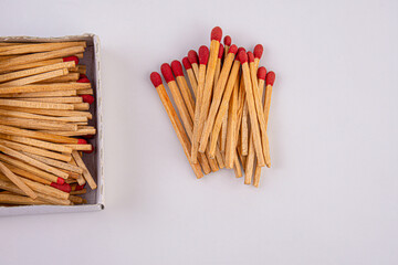 Red head matches in a white opened box on white background