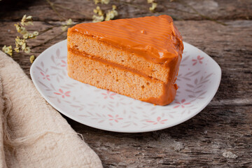 Triangle Thai tea cake on wooden background