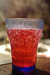 Close up shot of a red cold drinks with bubble