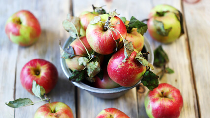 Selective focus. Fresh autumn apples in a bowl on a wooden surface. Harvest apples.
