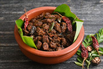 Kerala style beef or Mutton dry fry. delicious spicy Beef fry in clay pot . beef curry for ghee...