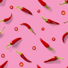 Seamless pattern made of red chili or chilli on pink background. Minimal food pattern. Red hot chilli seamless peppers pattern. Food background.