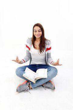Yong Asian youth girl in casual dress sit on floor book on lap hand yoga expression peace relaxed on white background