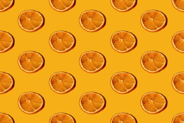 Orange art background. Seamless pattern. Citrus decor. Creative natural ornament texture. Round dry fruit slices symmetrical composition isolated on bright yellow.