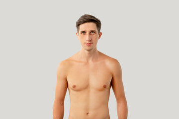 Obraz premium Handsome shirtless man. Healthy lifestyle. Male body care. Hygiene grooming. Attractive athletic guy looking at camera isolated on white copy space background.