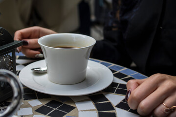 Girl with coffee in a white cup