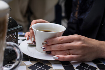 Girl with coffee in a white cup