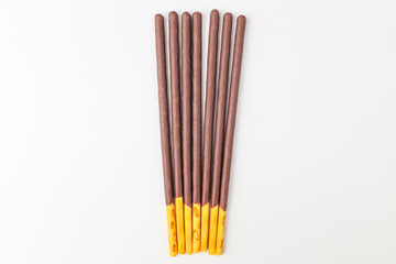 Chocolate sticks on white background