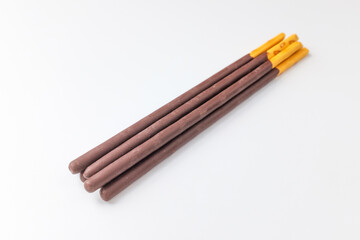Chocolate sticks on white background
