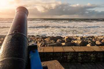 View on Atlantic ocean, Strandhill beach, county Sligo Ireland.View on Atlantic ocean, Strandhill beach, county Sligo Ireland. Old cannonball pointed to the water, Sunset time