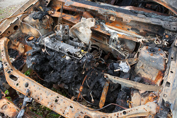 A set on fire stands on the side of a busy street next to the forest