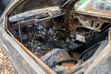 Fototapeta premium A set on fire stands on the side of a busy street next to the forest