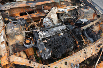 A set on fire stands on the side of a busy street next to the forest