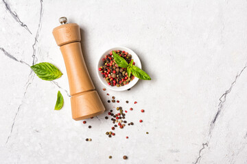 Bright spices, basil leaves with pepper mill for tasty cooking