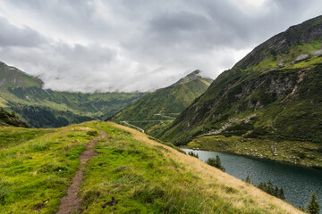 Fototapeta na wymiar hiking trail in the green nature with a mountain lake