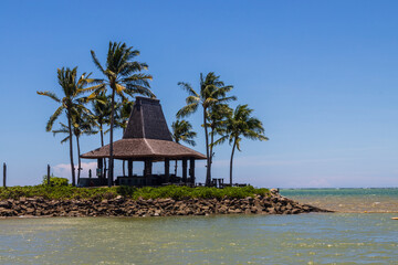 Beach and palm trees over the clear blue sky In Kota Kinabalu Beach, Sabah, Malaysia