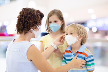 Mother and child with face mask and hand sanitizer