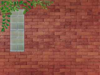 transparency glass block on brown clay bricks wall background with green bignonia leaves decoration at top rigth corner for interior modern design for energy saving and environment conservation