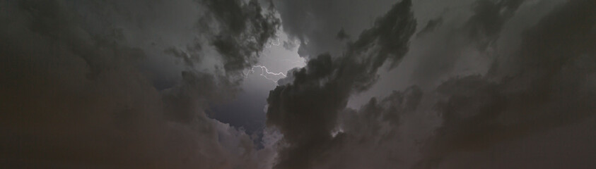 Picture of a flash in the night sky with glowing clouds