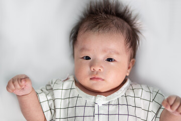 Portraiture image of Three month old Asian Cute little baby boy lsolated on white background