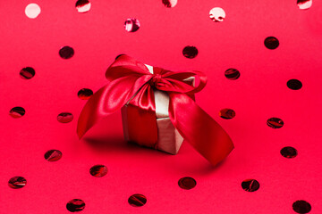 Christmas gift and Valentine's day in wrapping paper on a red background