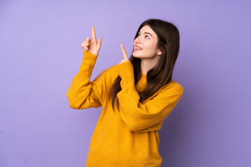 Young Ukrainian teenager girl over isolated purple background pointing with the index finger a great idea