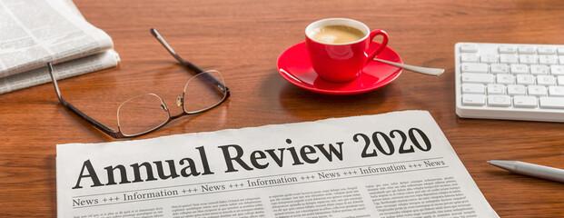 A newspaper on a wooden desk - Annual review 2020