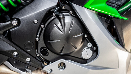 Black cylinder of engine of motorcycle closeup. Part sport green bike, side view. Motorcycle...