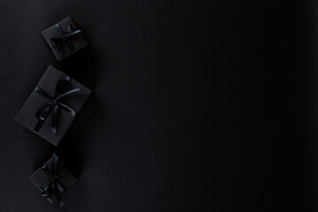 Black gift paper black background. Dark concept, sales. Copy space.
