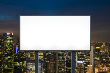 Blank white road billboard with Singapore cityscape background at night time. Street advertising...