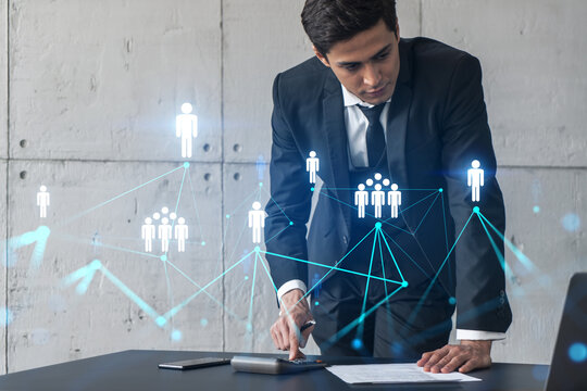 Businessman in office signs contract and social media hologram. Double exposure. Formal wear. Concept of people smm data. - Powered by Adobe