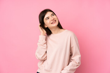 Young Ukrainian teenager girl over isolated pink background thinking an idea